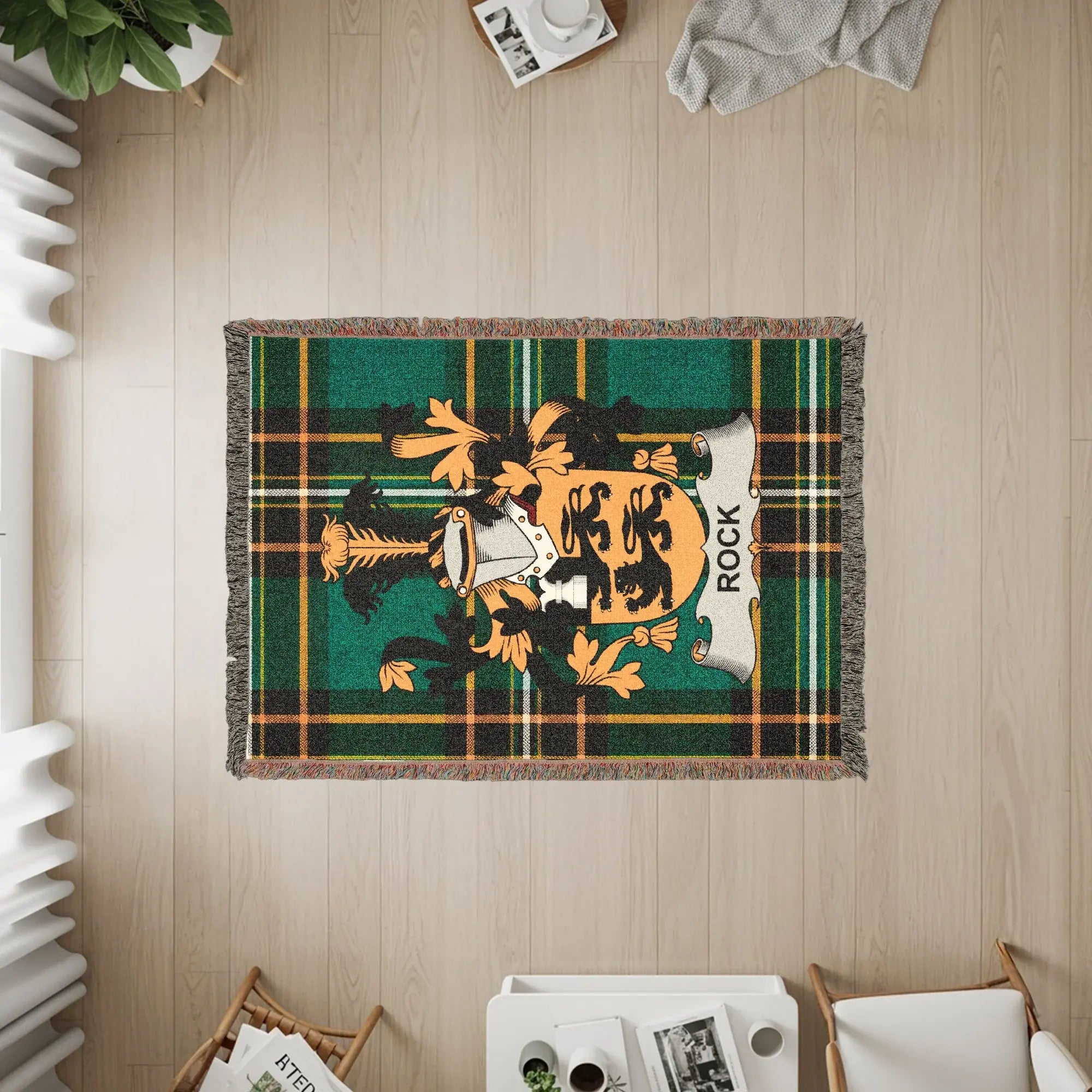 Green and gold tartan blanket featuring a coat of arms with the name "ROCK".