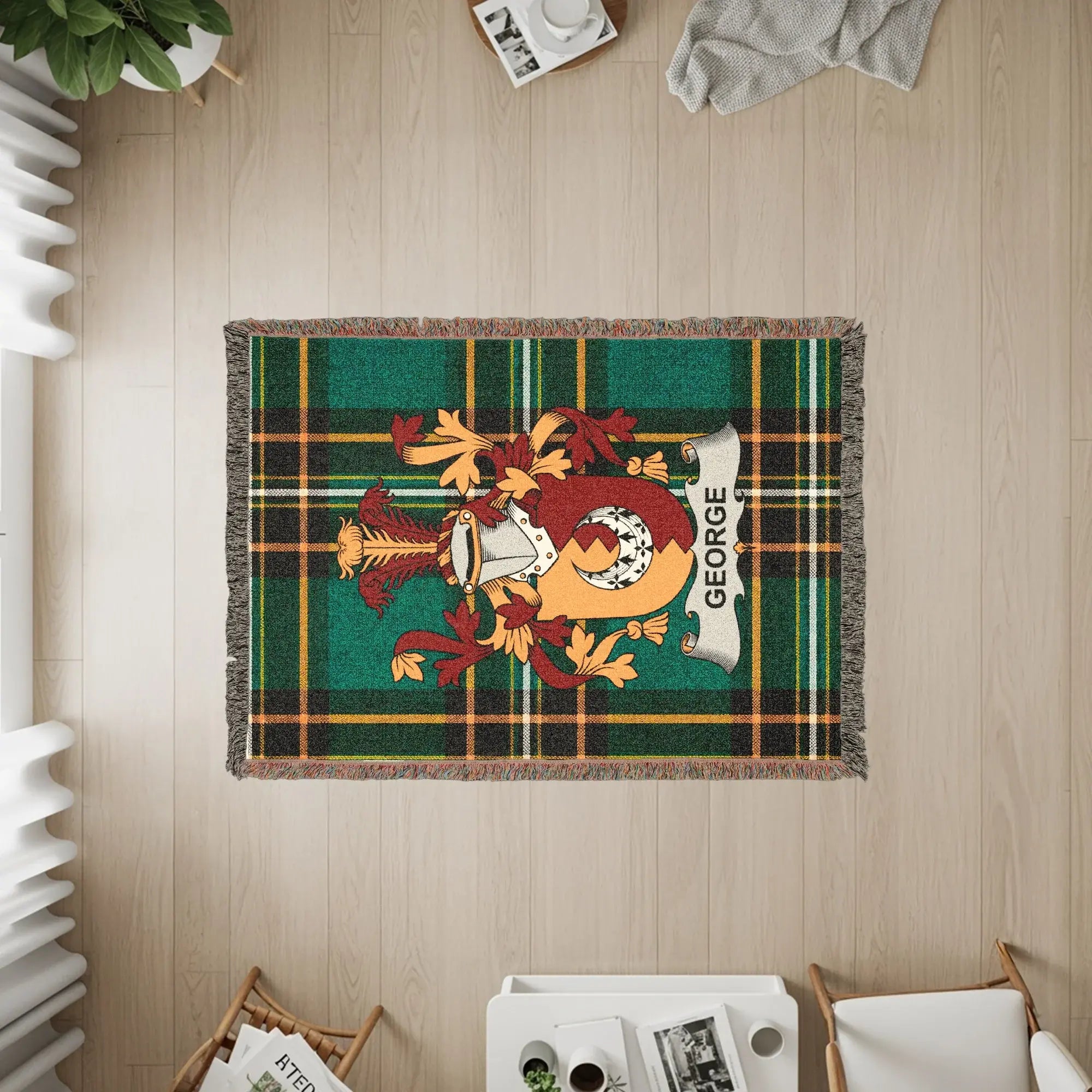Tapestry throw with green tartan and George family crest.