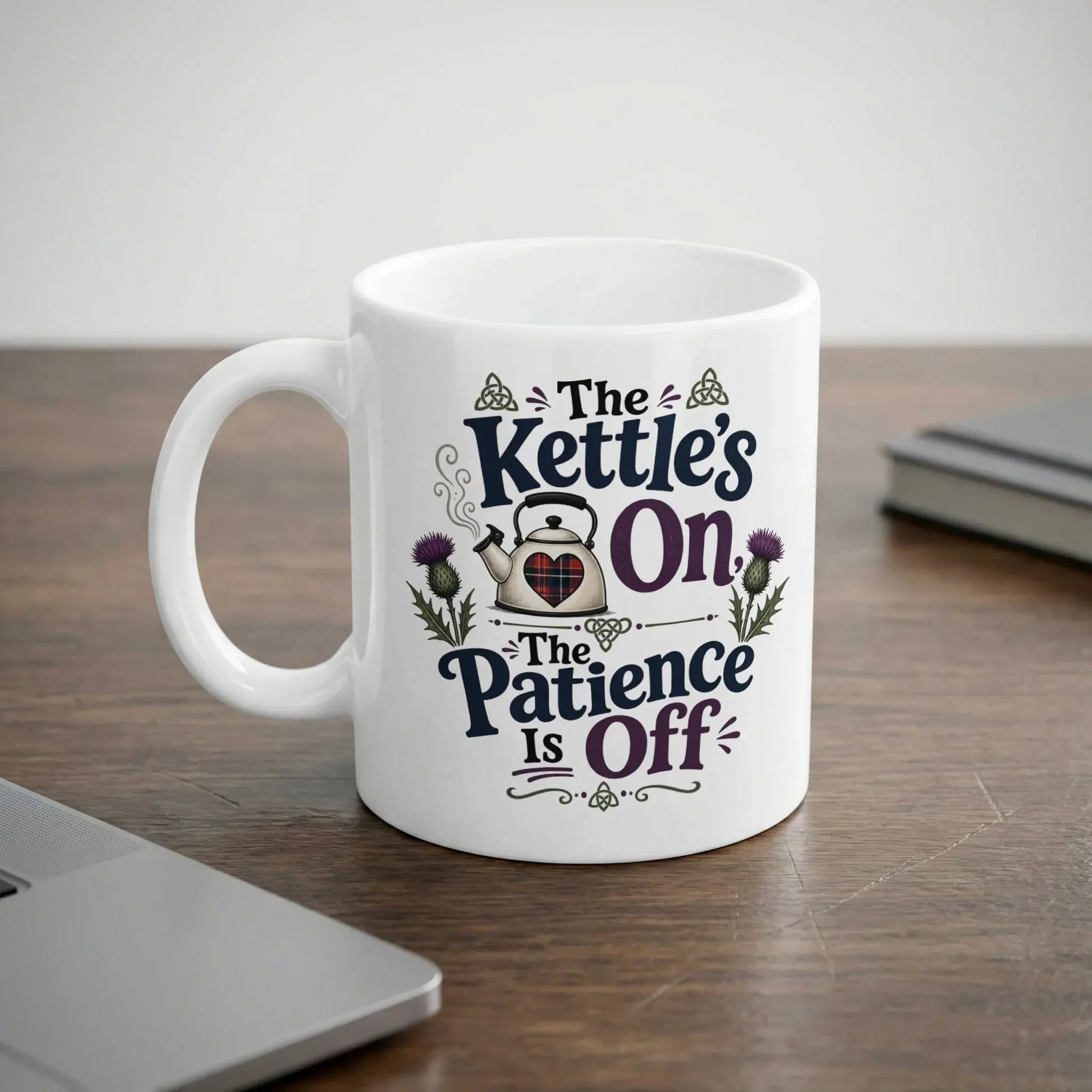 White mug with text "The Kettle's On, The Patience Is Off" and thistle design.