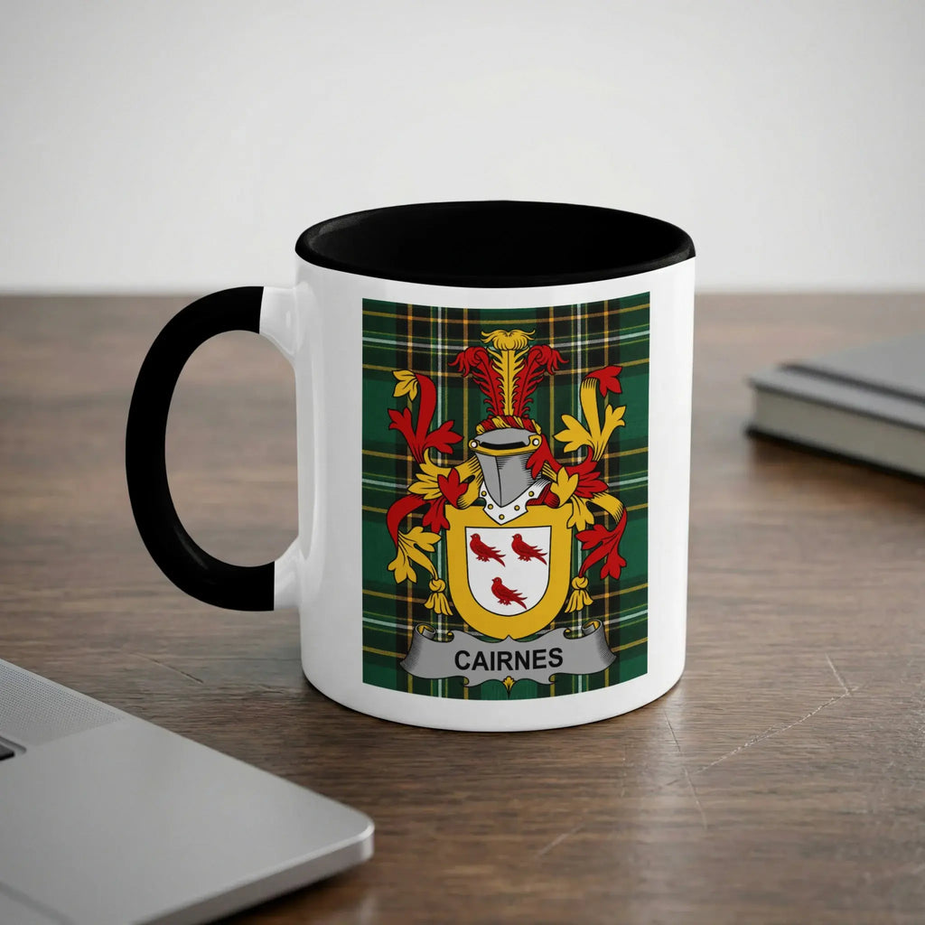 White mug with black rim featuring the "Cairnes" family crest on a plaid background.