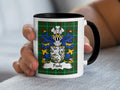 Mug with Poole family crest on green tartan background.