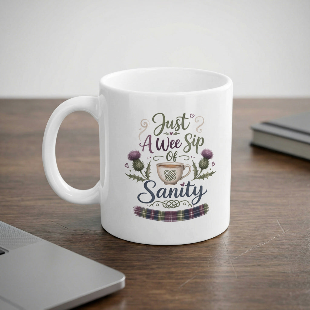 White mug with "Just A Wee Sip of Sanity" and thistle design.