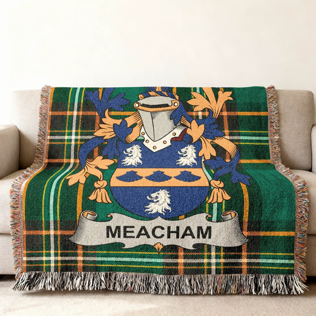 Meacham family crest on a tartan throw blanket draped over a sofa.