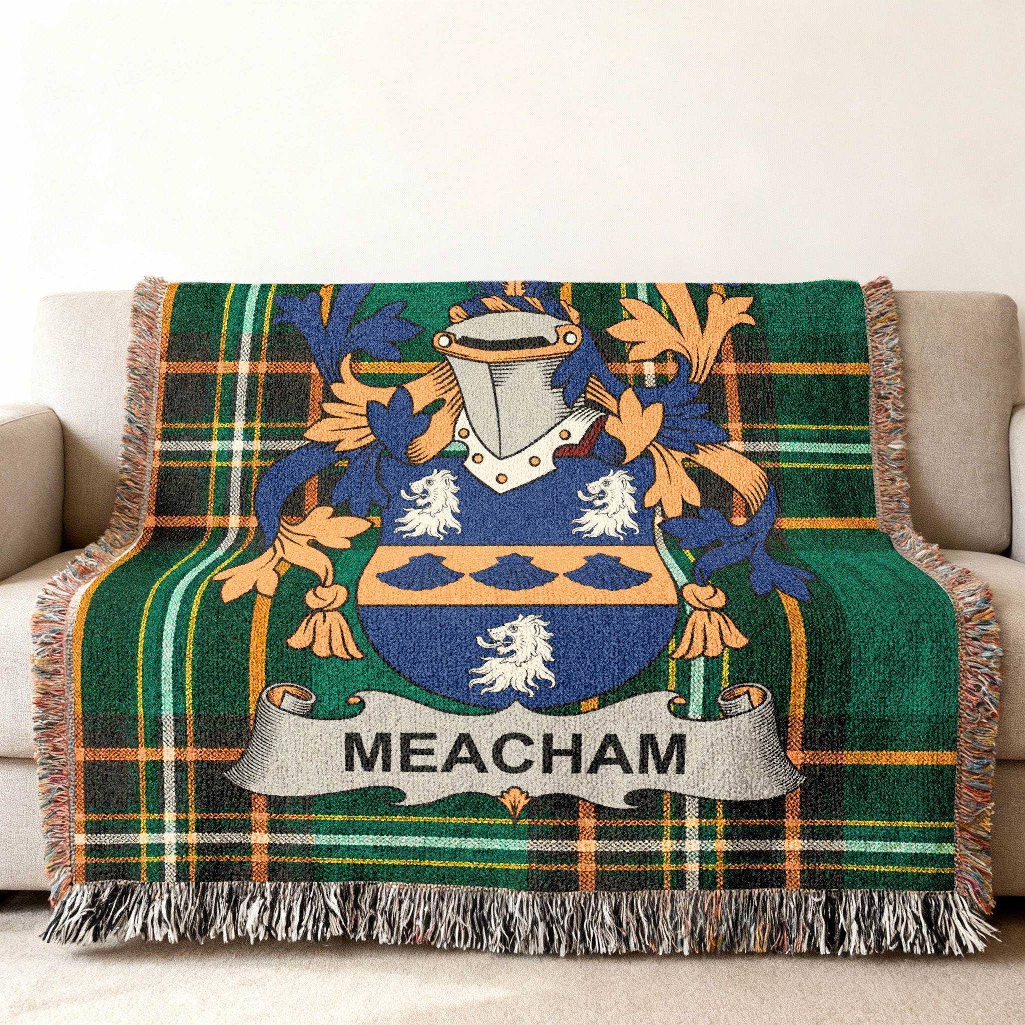 Meacham family crest on a tartan throw blanket draped over a sofa.