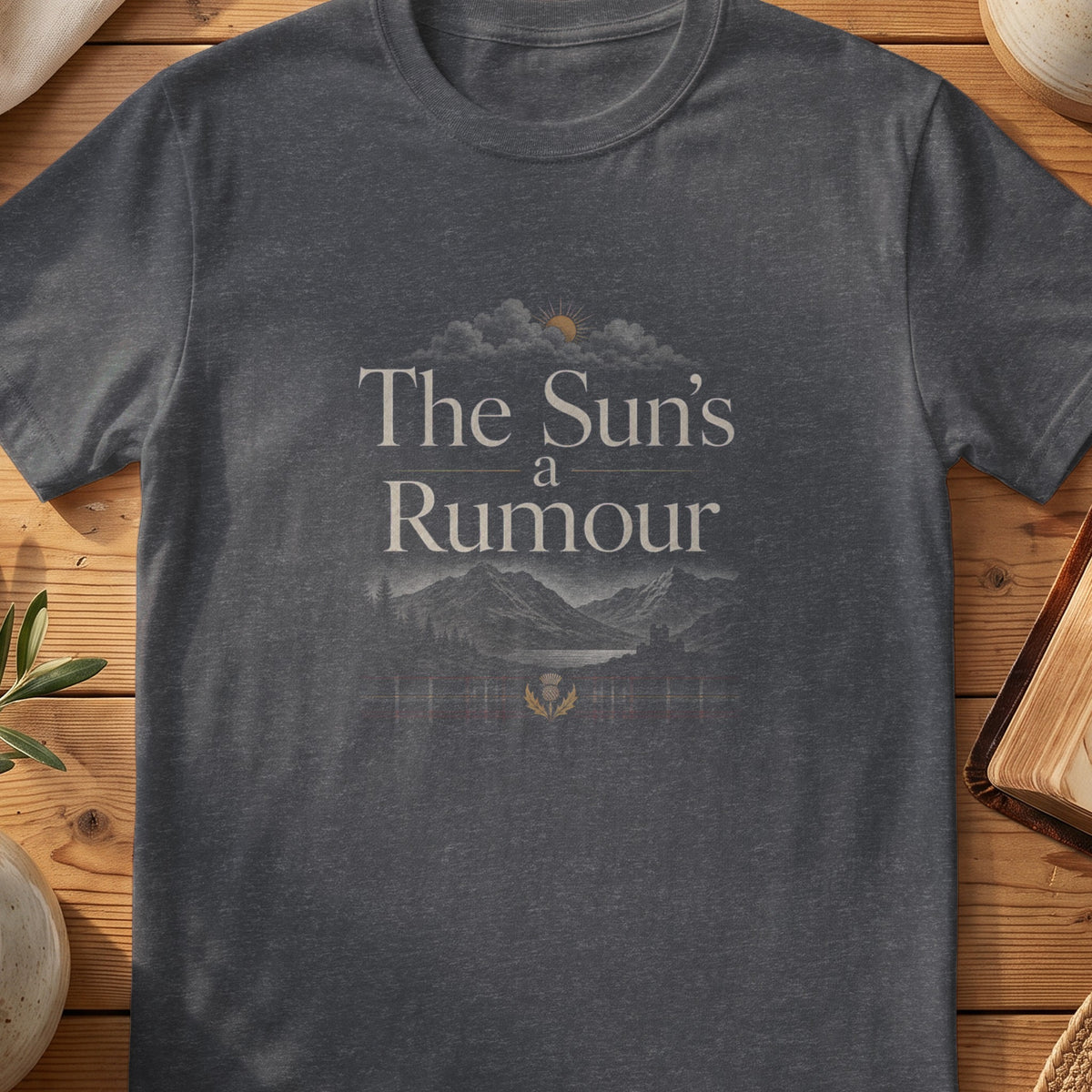 Dark grey Gildan 64000 unisex T-shirt flatlay with The Sun's a Rumour Scottish graphic design