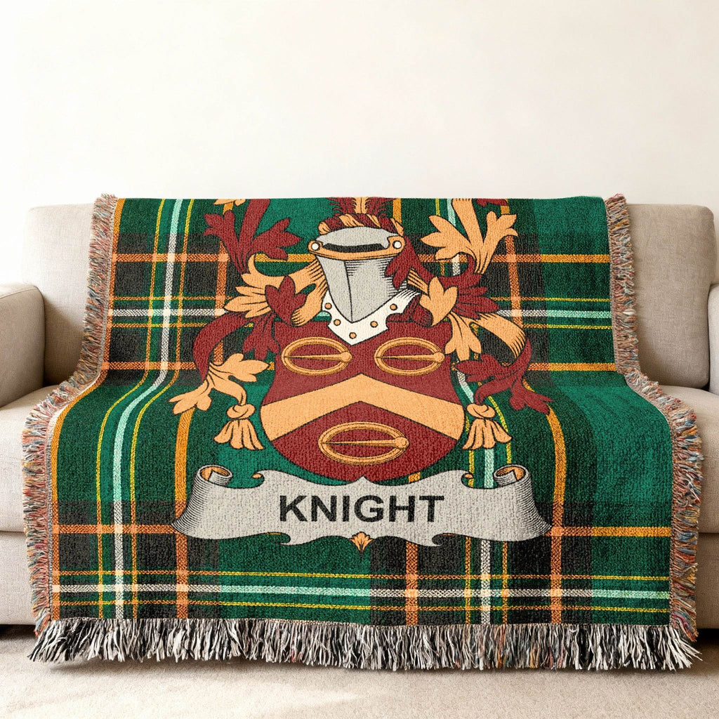 Woven blanket with the Knight family crest on a green plaid background.
