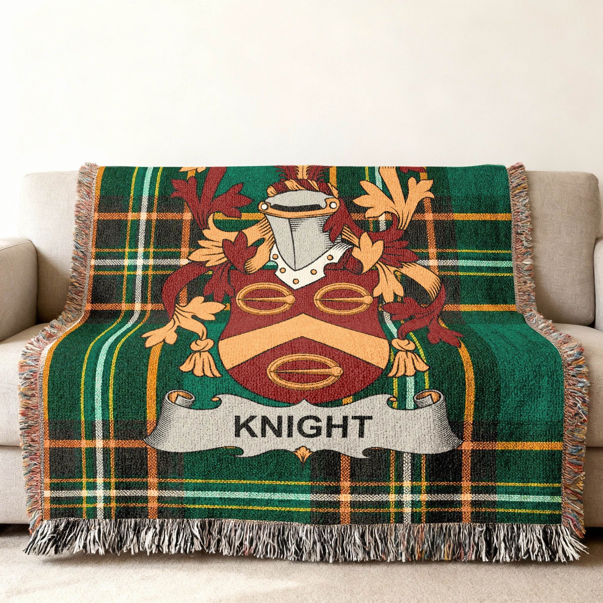Woven blanket with the Knight family crest on a green plaid background.