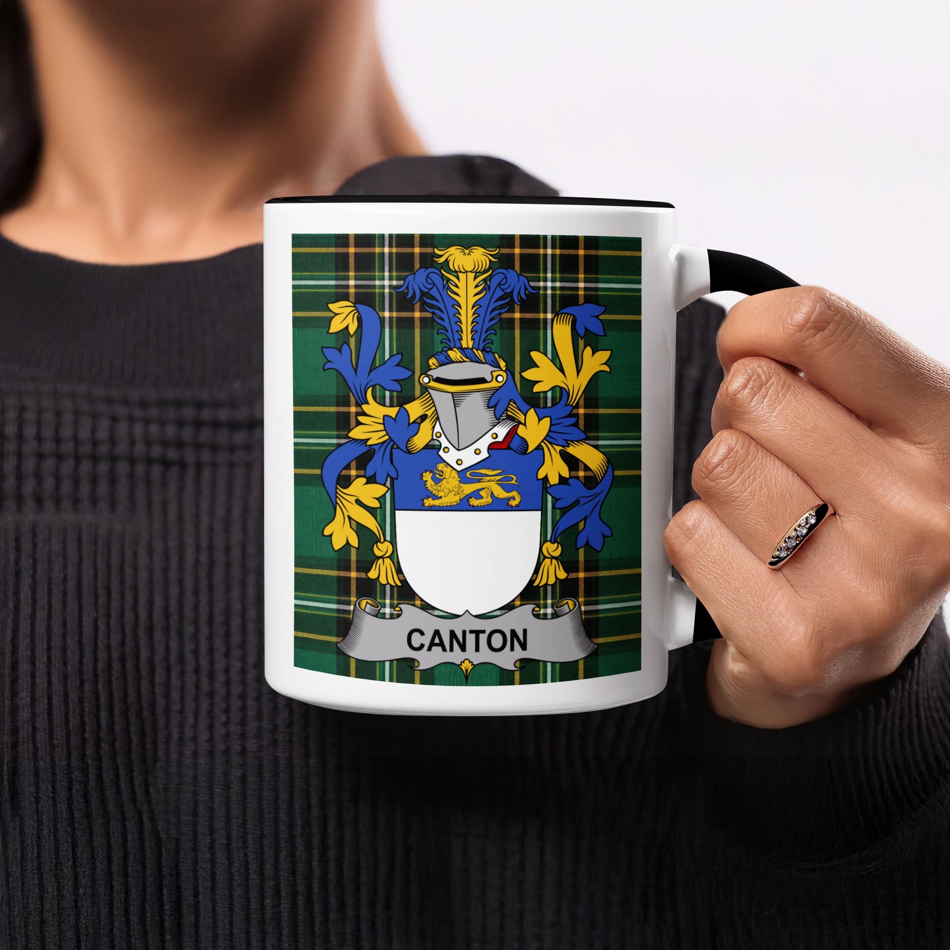 White mug with black trim displaying a green tartan and the "Canton" coat of arms.