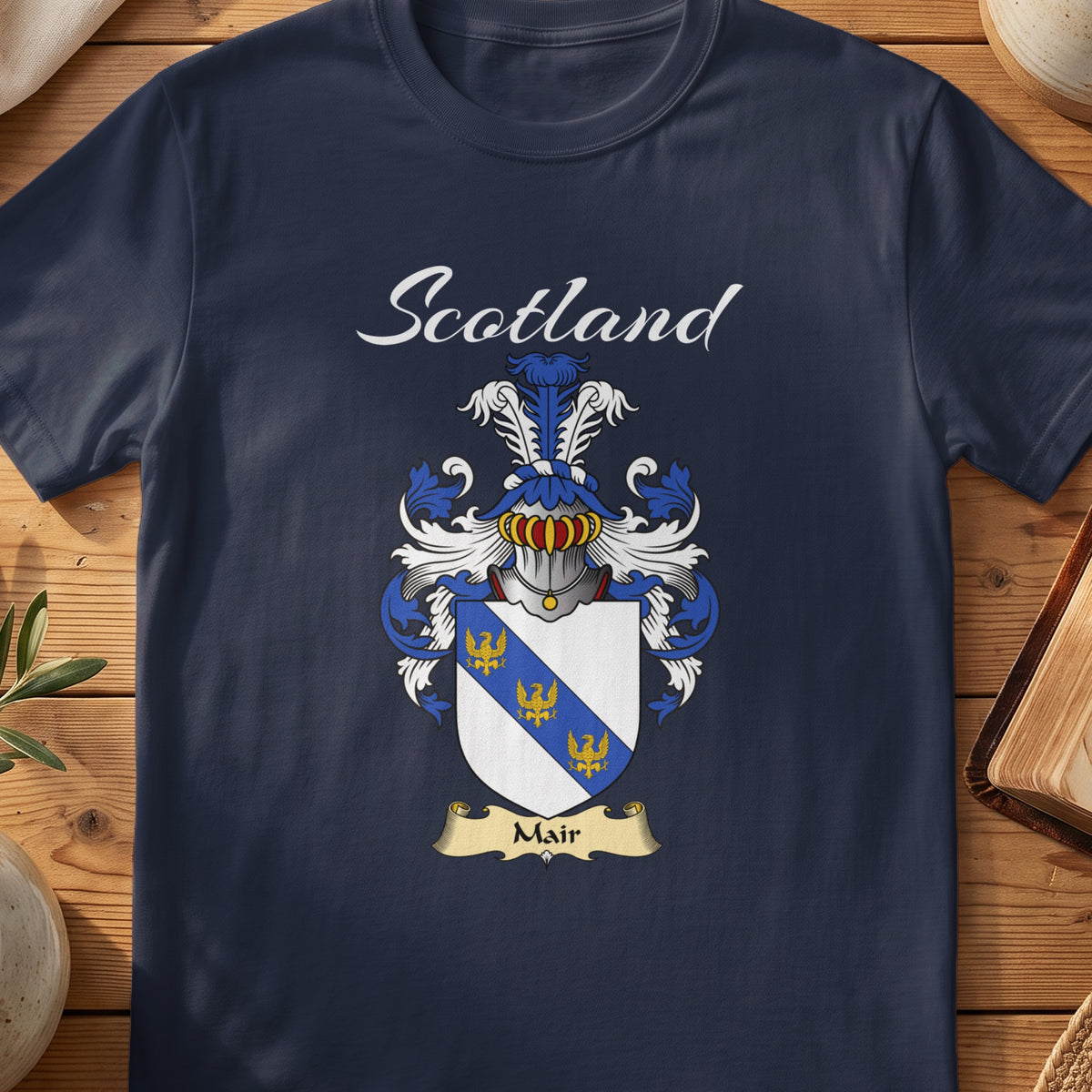 Navy Mair family shield T-shirt featuring a blue diagonal band with small gold motifs