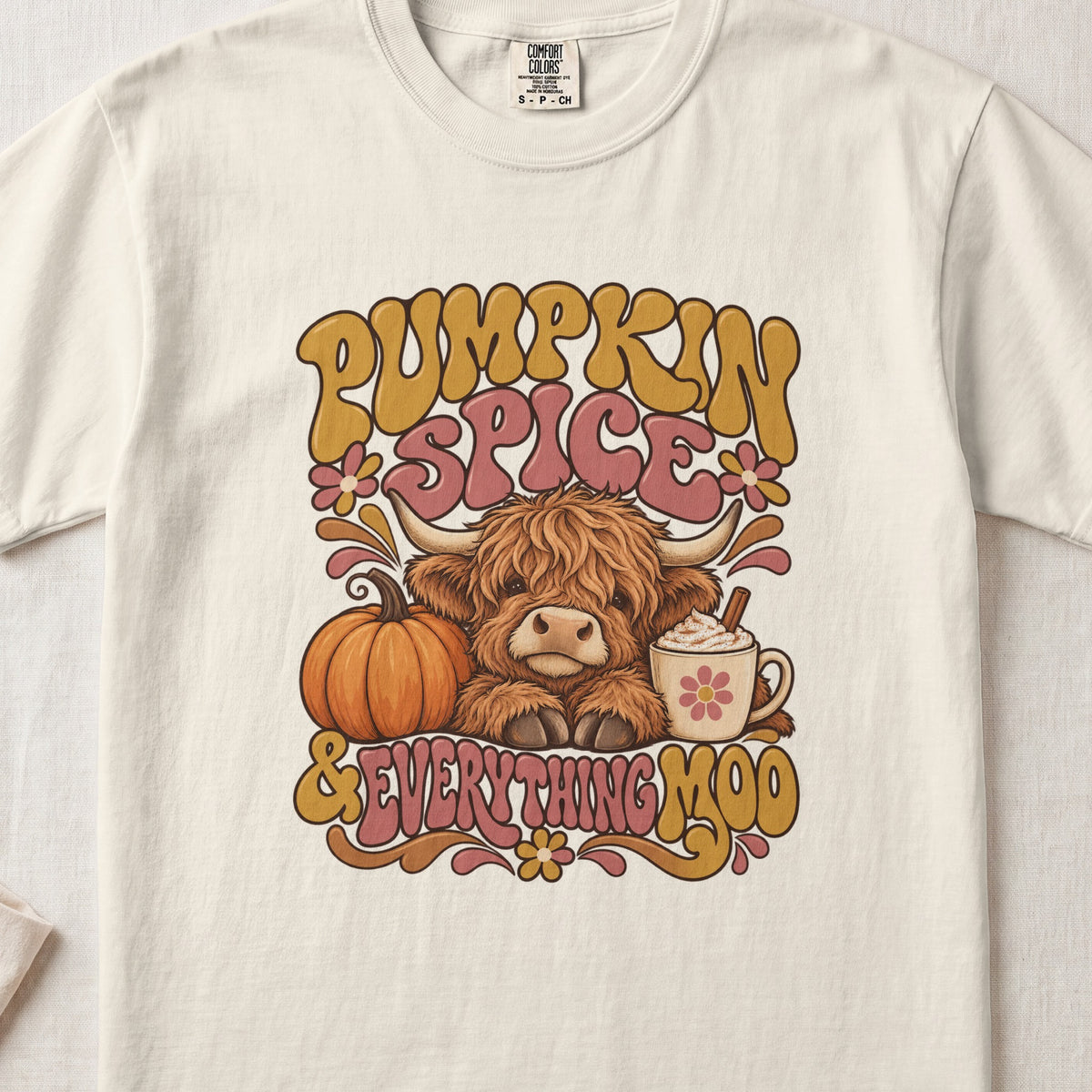 Pumpkin Spice & Everything Moo Highland cow design on an Ivory Comfort Colors 1717 T-shirt, flat lay