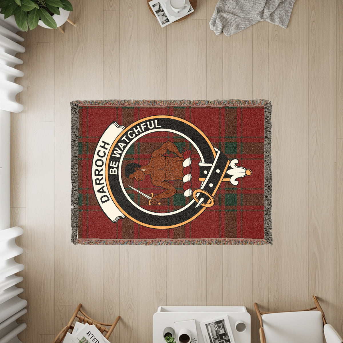 Darroch woven blanket displayed on a wall, featuring the crest badge and tartan background