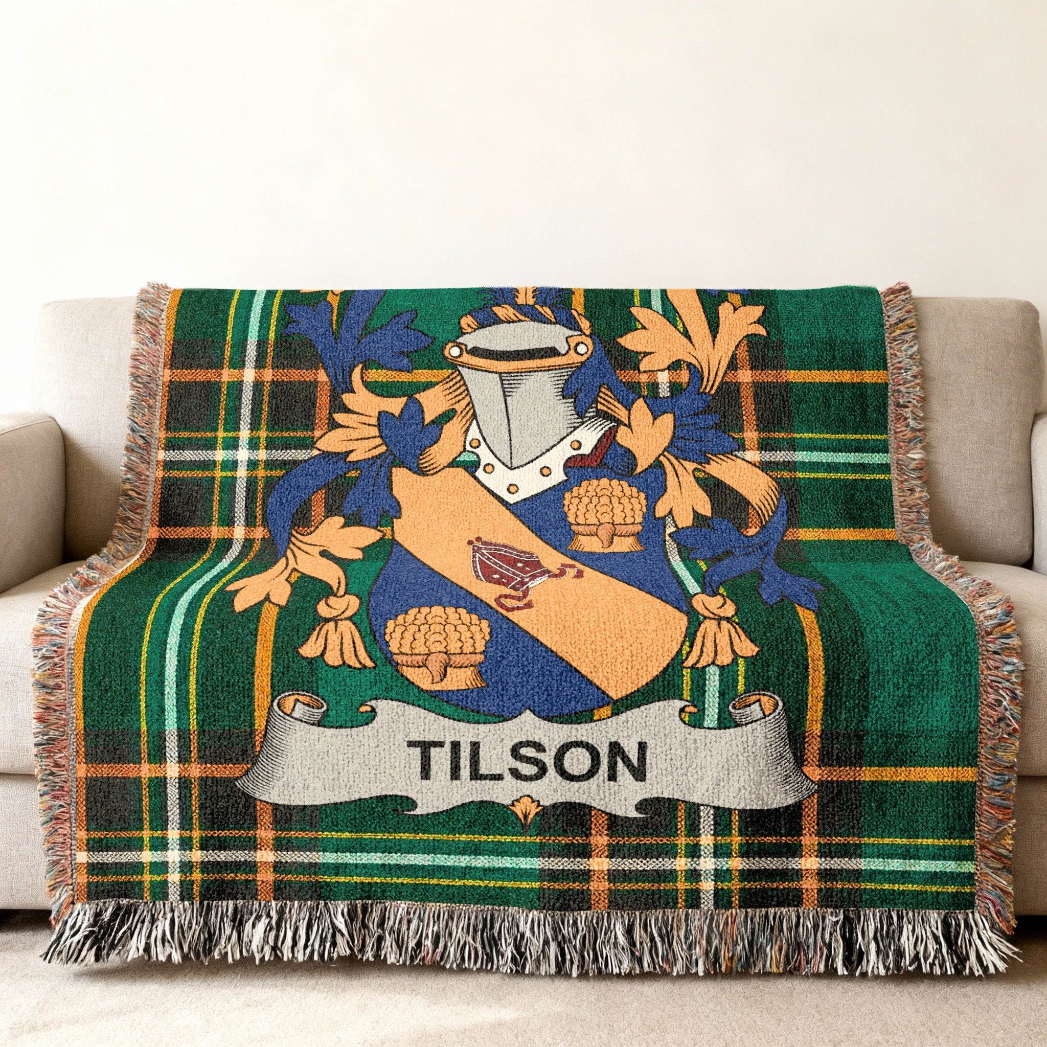Tilson family crest on a green plaid woven throw blanket.
