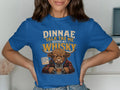 Highland cow in plaid shirt on blue t-shirt with "Dinnae talk tae me before my whisky" text.