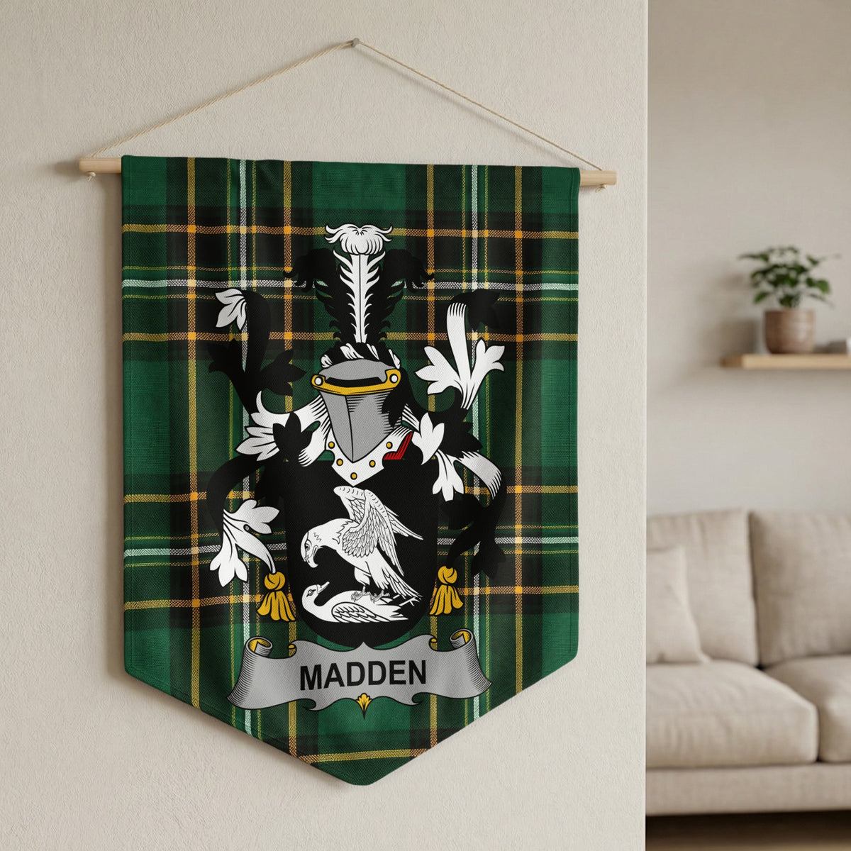 Madden family crest on green tartan fabric banner hanging on wall.