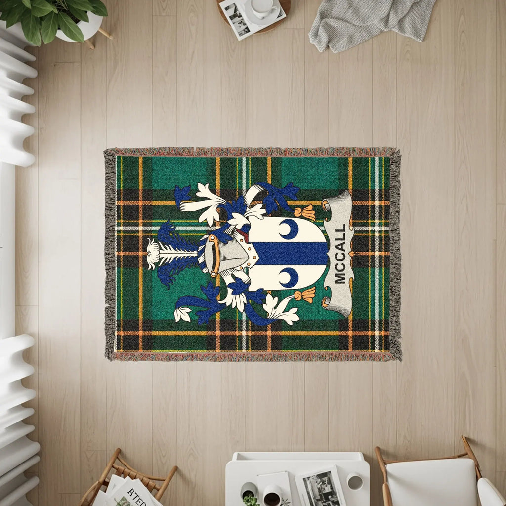 McCall family crest on a green and blue plaid woven throw blanket.
