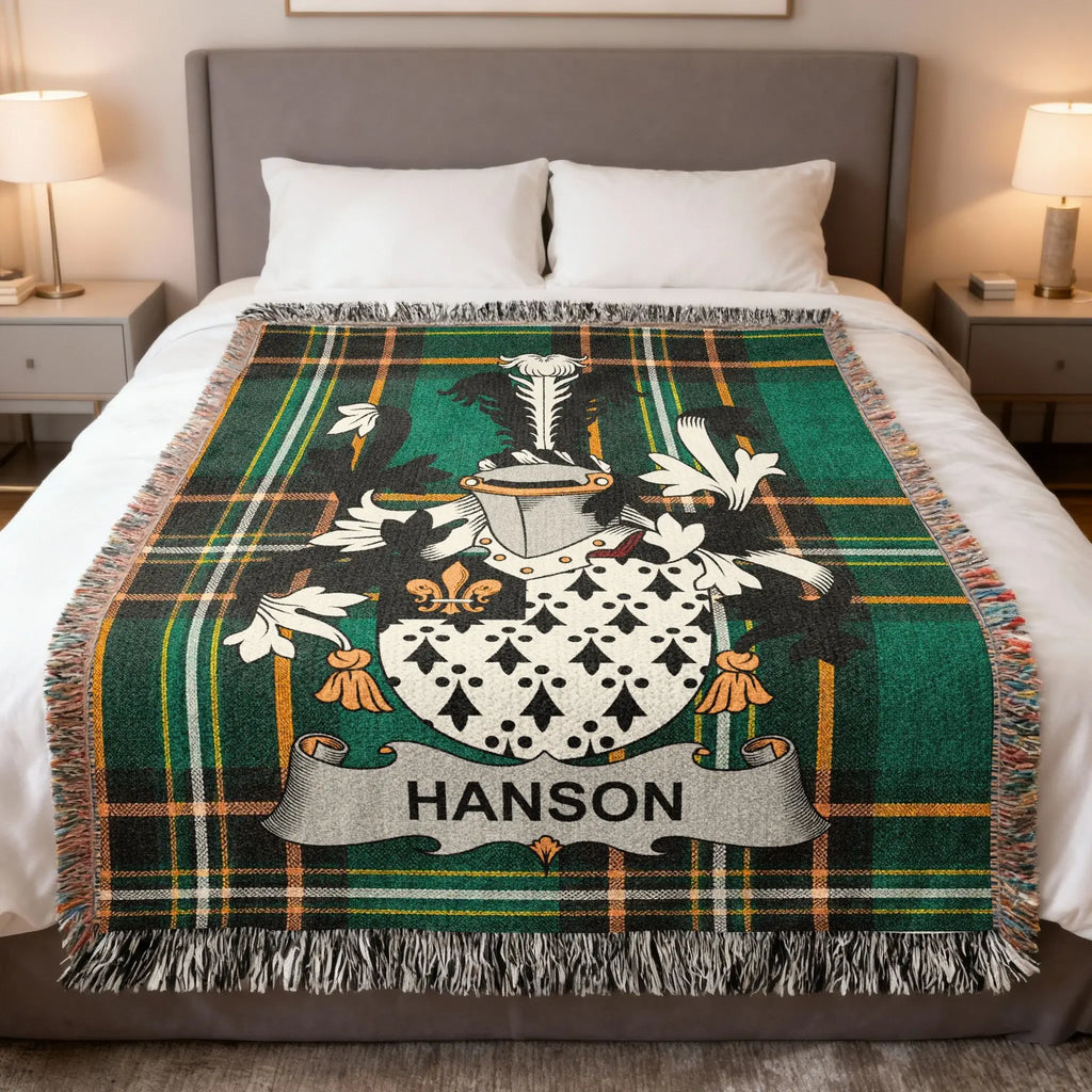 Tartan blanket with "HANSON" crest on a bed.