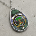 Crosbie clan Scottish tartan necklace with clan crest on tartan background