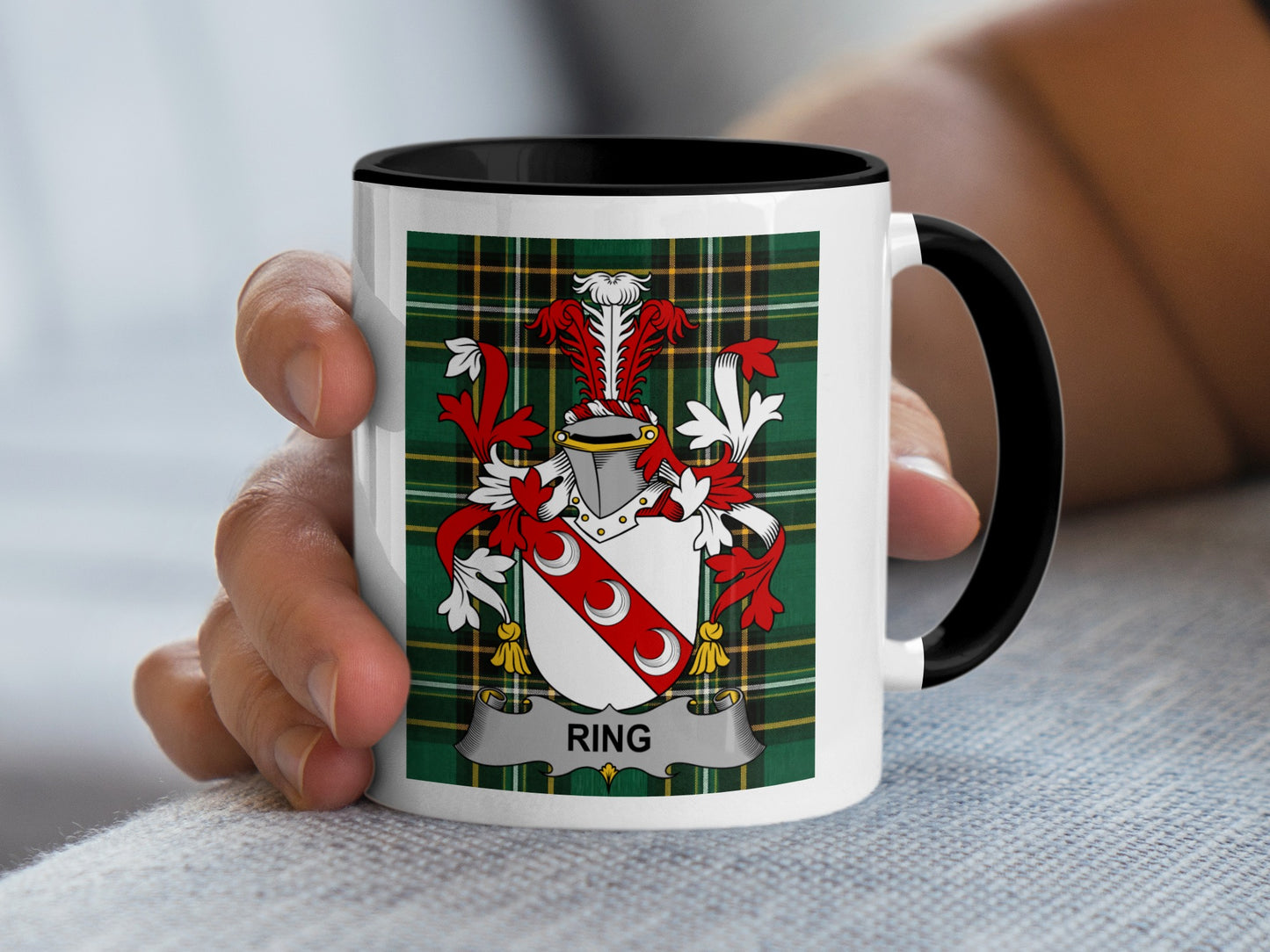 Mug with the Ring family crest displayed on a plaid background.
