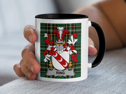 Mug with the Ring family crest displayed on a plaid background.