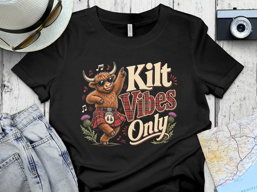 T-shirt with dancing Highland cow wearing sunglasses and kilt, "Kilt Vibes Only" text.