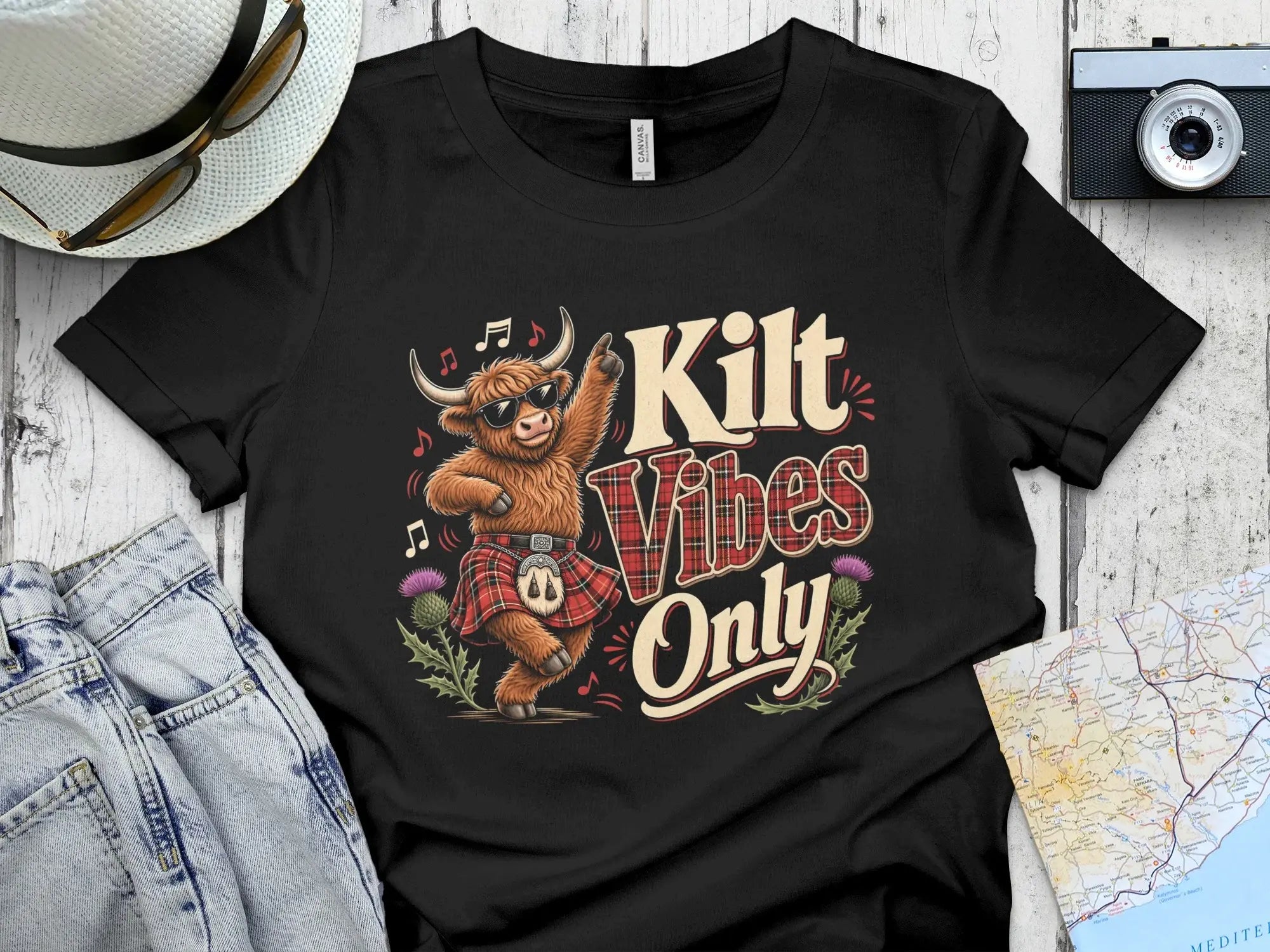 T-shirt with dancing Highland cow wearing sunglasses and kilt, "Kilt Vibes Only" text.