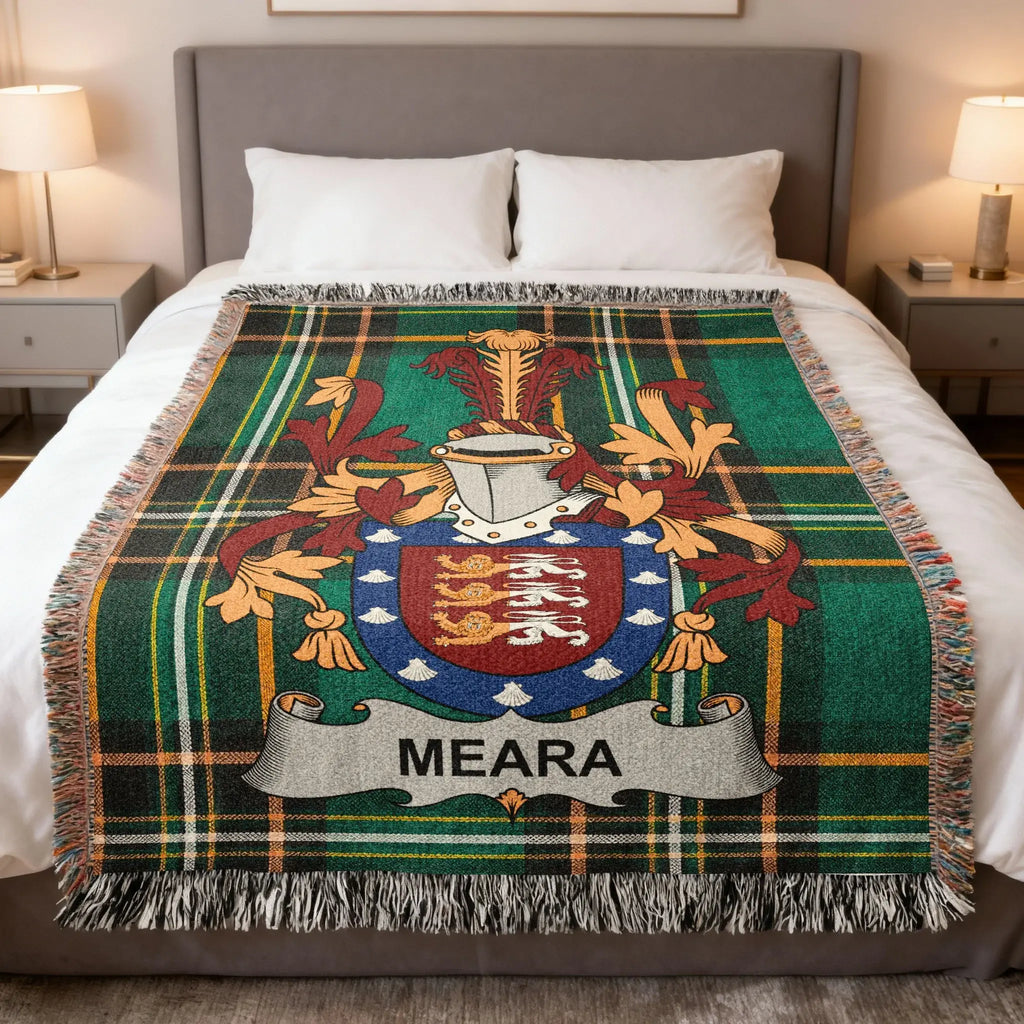 MEARA clan tartan blanket with coat of arms displayed on a bed.
