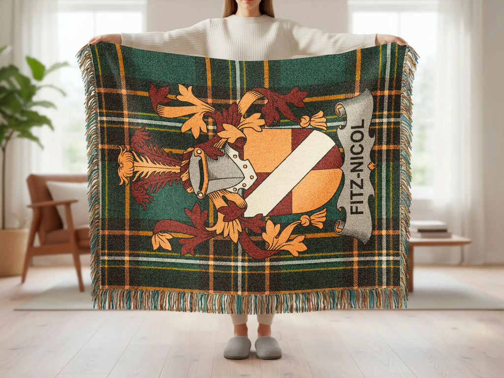 Tartan throw blanket with Fitz-Nicol crest and fringed edges.