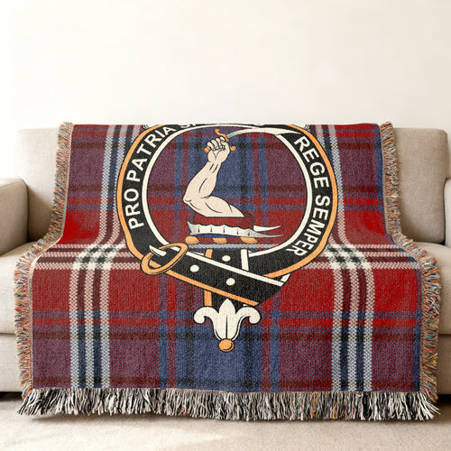 Close view of the Ainslie woven blanket draped over a sofa, showing the crest and fringed edges