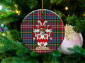 MacCormack Scottish clan ceramic ornament with family crest on a Caledonia tartan background, hanging on a Christmas tree