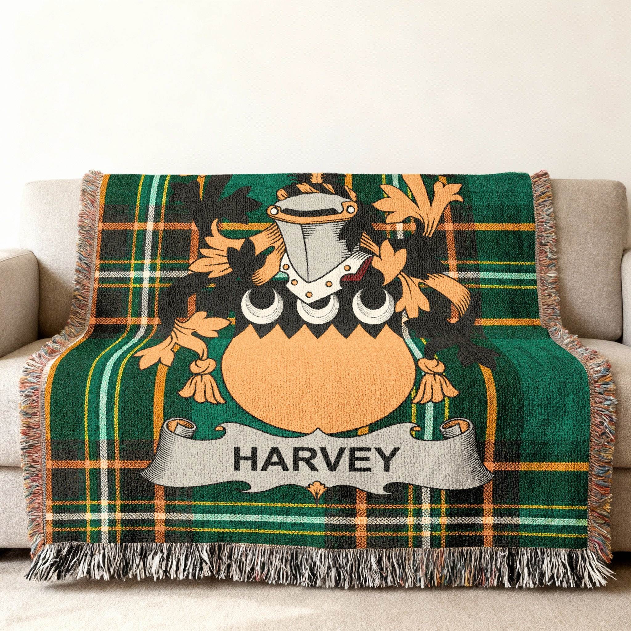 Harvey family crest on a green tartan throw blanket on a sofa.