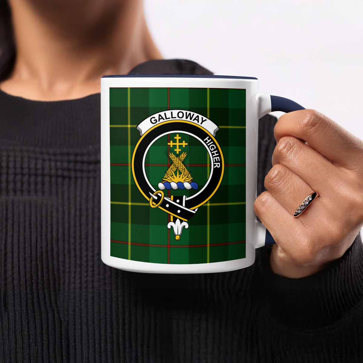 Close-up lifestyle view of Galloway Scottish heritage crest artwork on a navy 11 oz accent mug with a tartan background