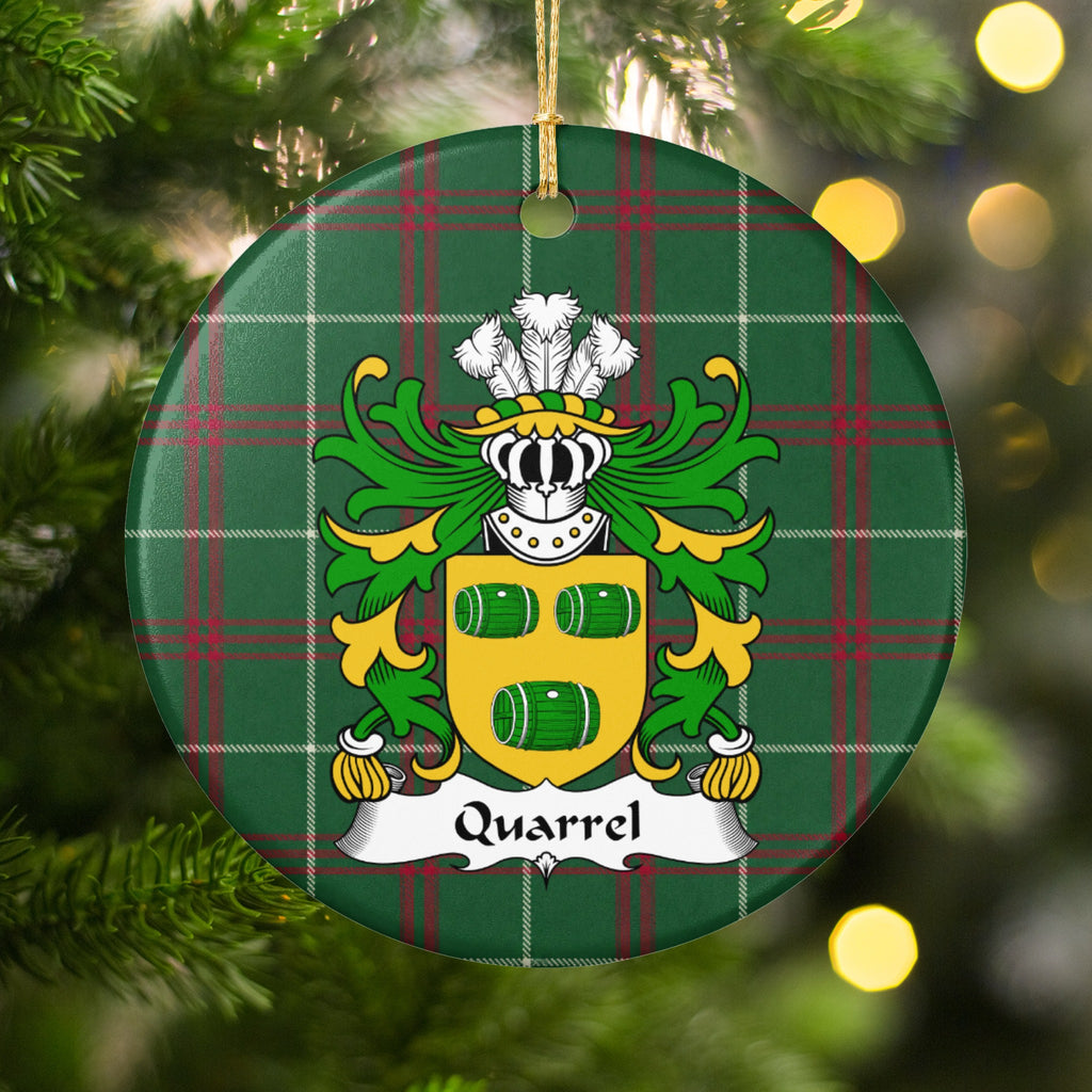 Quarrel round Welsh National Tartan ornament hanging on a Christmas tree with warm lights, featuring three green barrels on a gold shield.