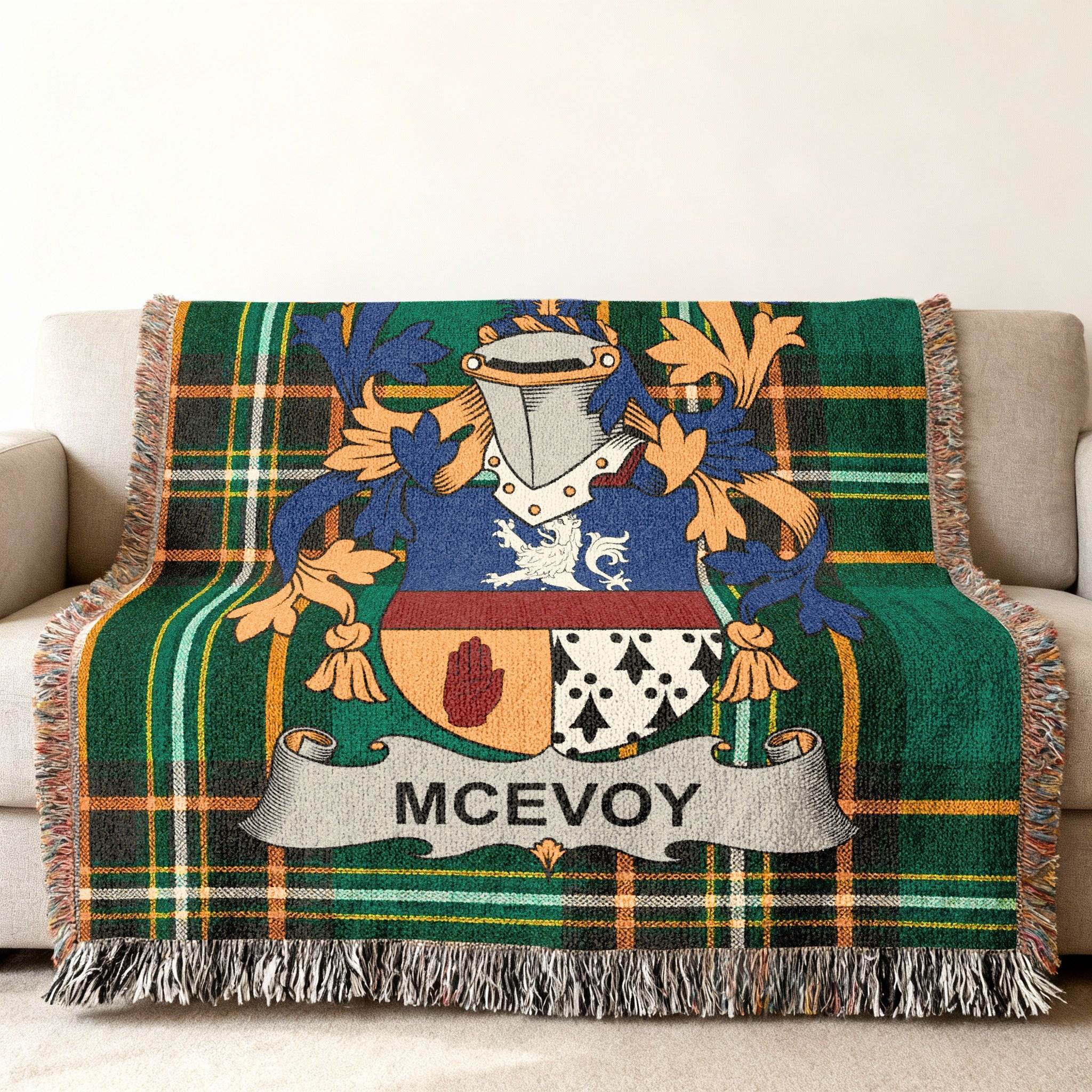 McEvoy family crest on a green tartan plaid throw blanket with fringe.