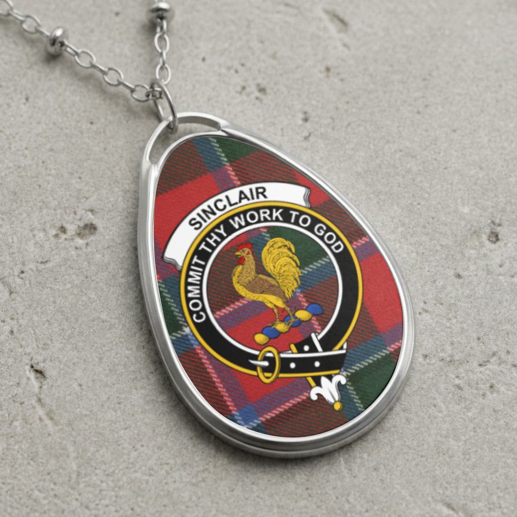 Oval pendant with Sinclair tartan, rooster crest, and Latin motto on beaded silver chain.