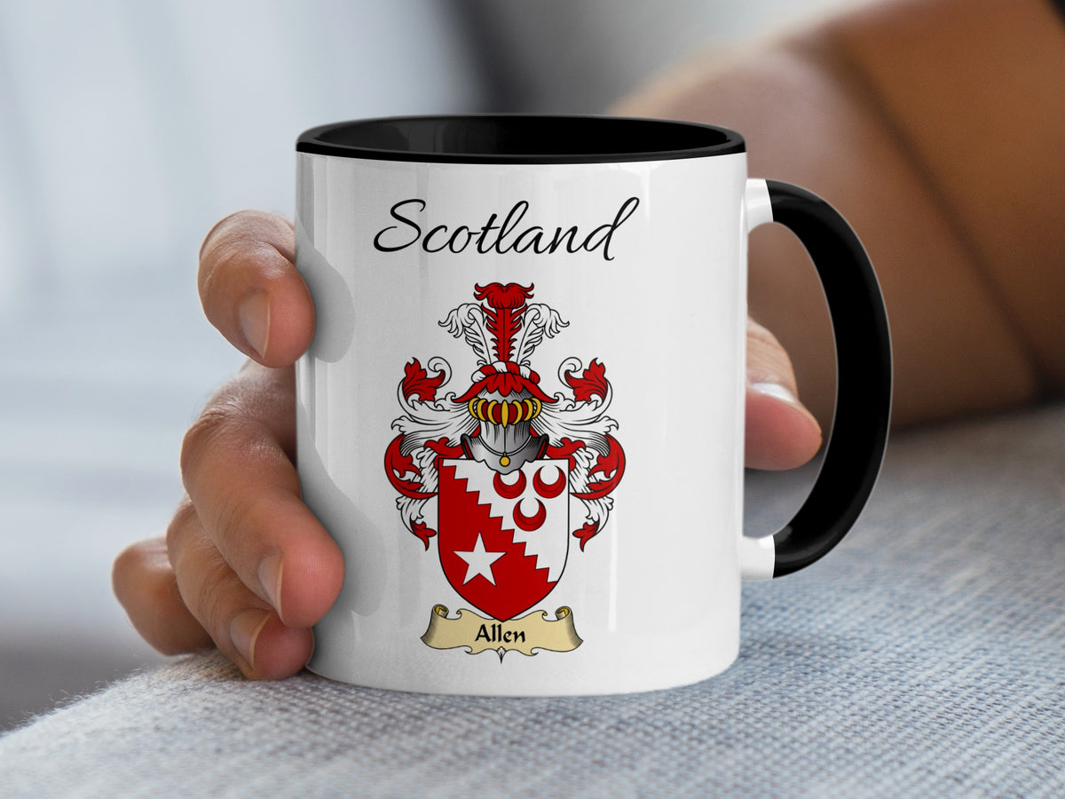 Hand-held white Allen Scottish family shield mug with black handle, showing “Scotland” and a red-and-silver shield with a red bird-like figure and radiating lower pattern.