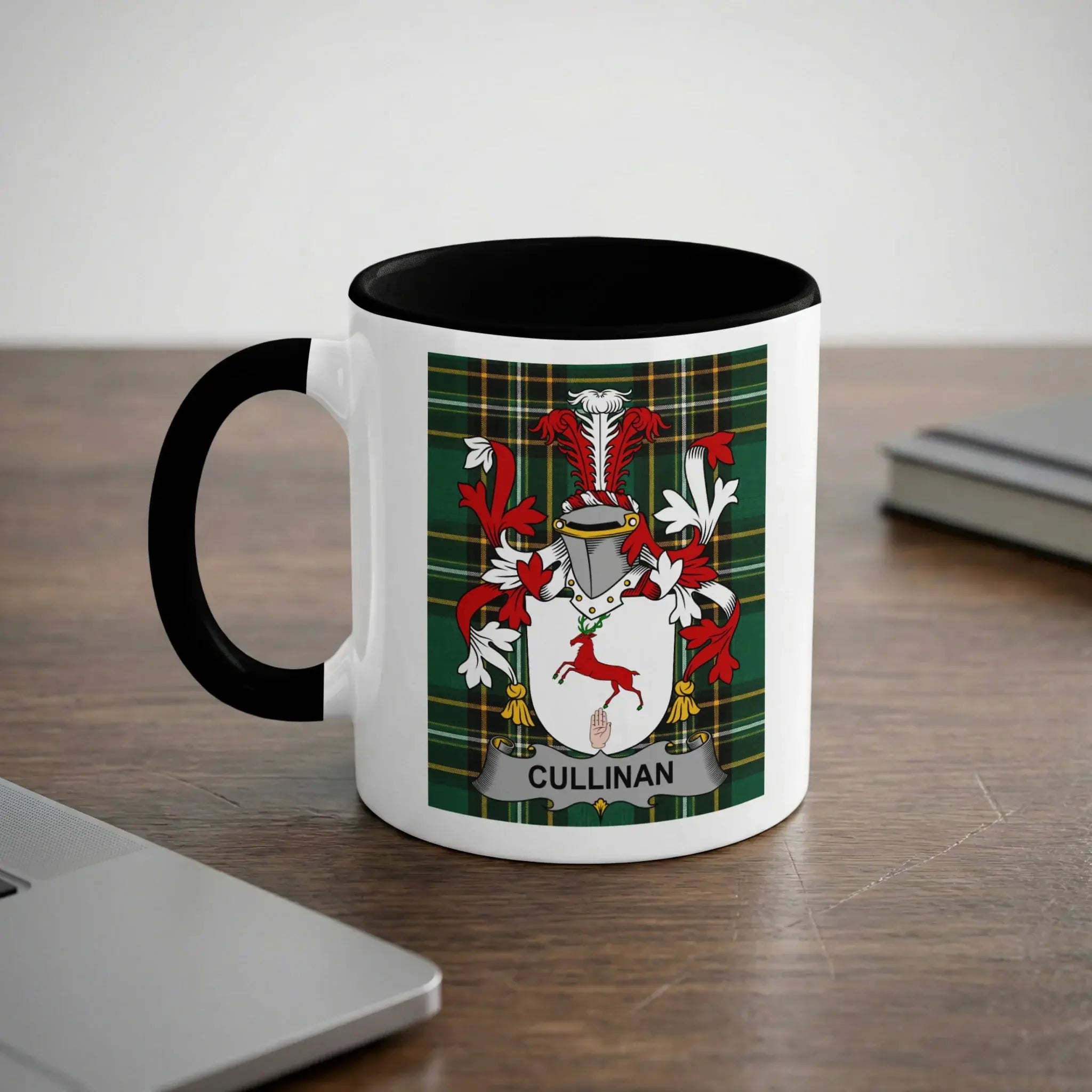 White mug with black handle and rim, displaying the Cullinan family crest.