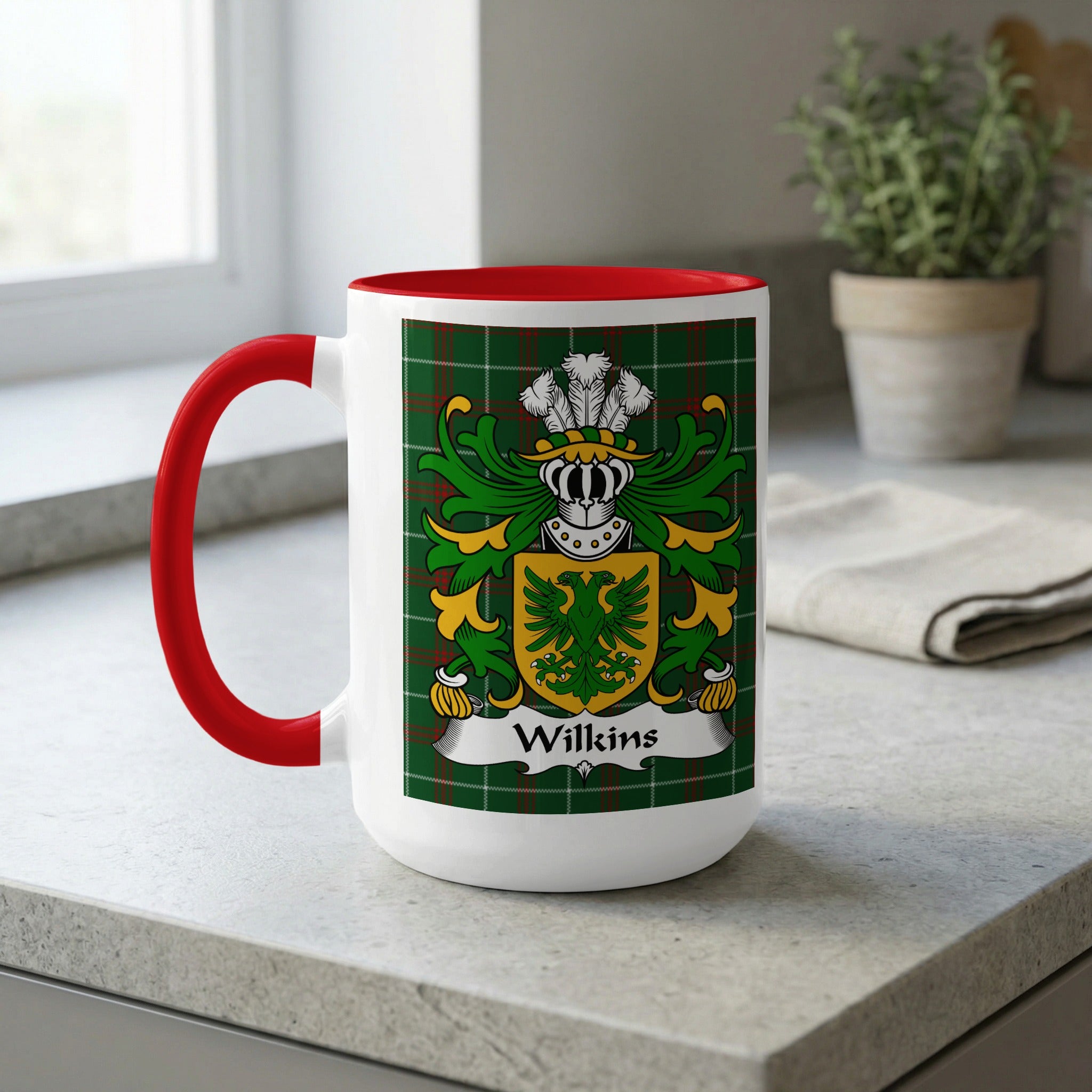 White mug with red handle featuring the Wilkins family crest on a tartan background.