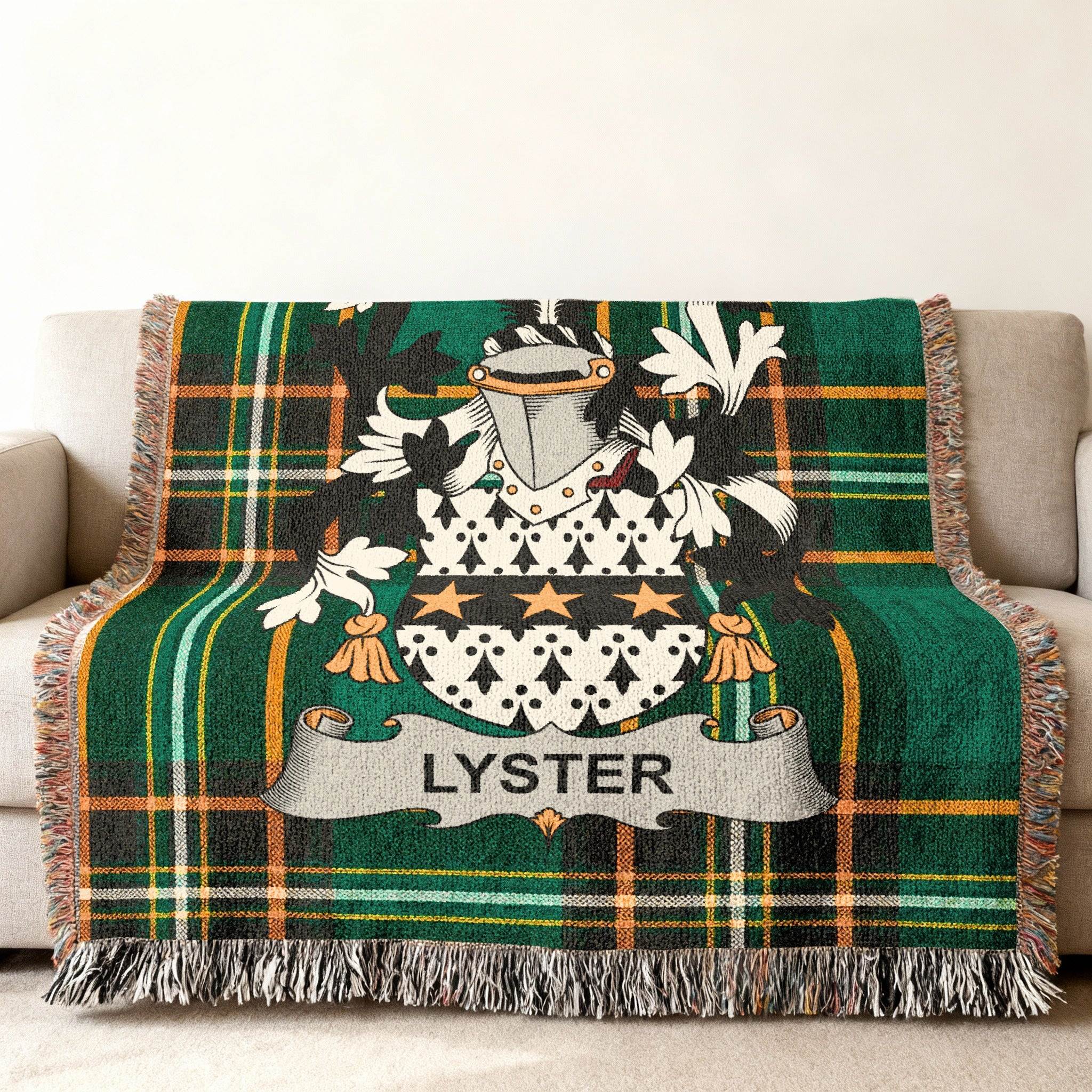 Green plaid throw blanket with coat of arms and "LYSTER" name.