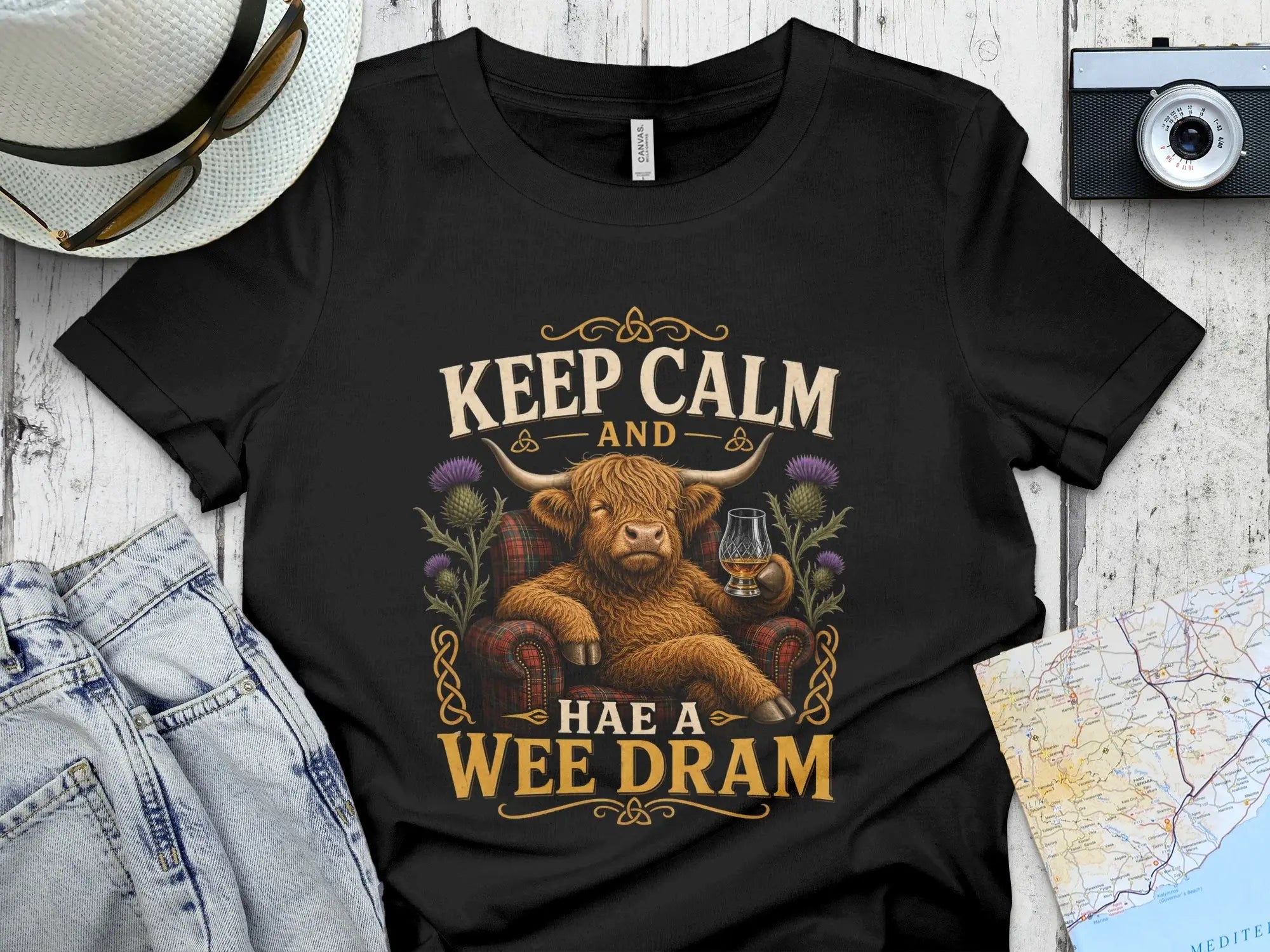 Highland cow sitting in chair with whiskey, text reads "Keep Calm and Have a Wee Dram".
