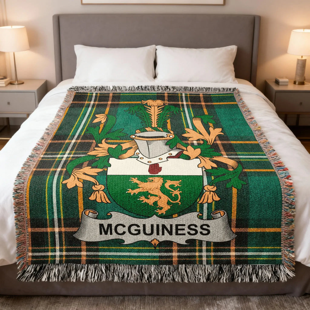 McGUINNESS tartan blanket with coat of arms on a bed.