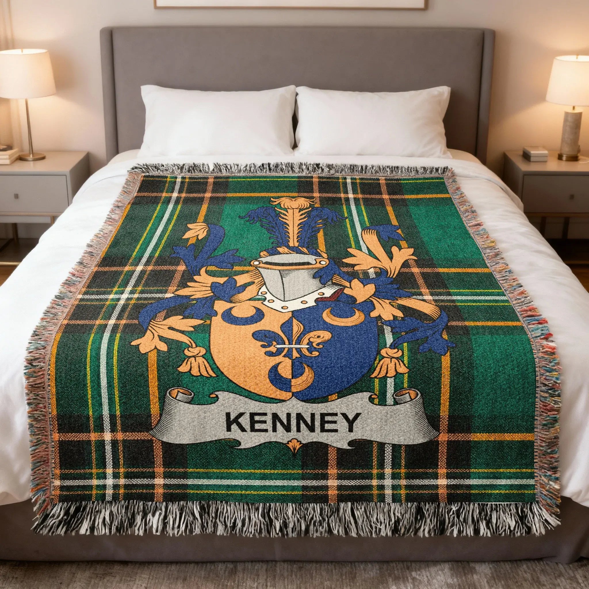 Plaid blanket with Kenney family crest on a bed.