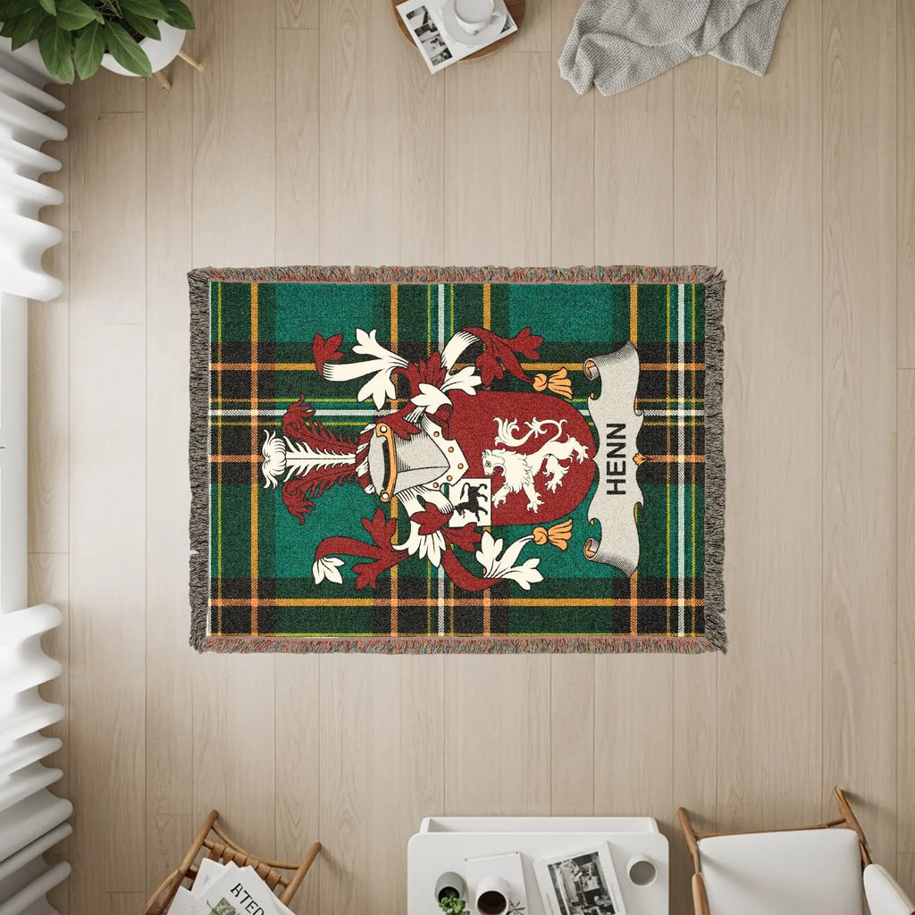 Henn family crest on a green plaid woven throw blanket.