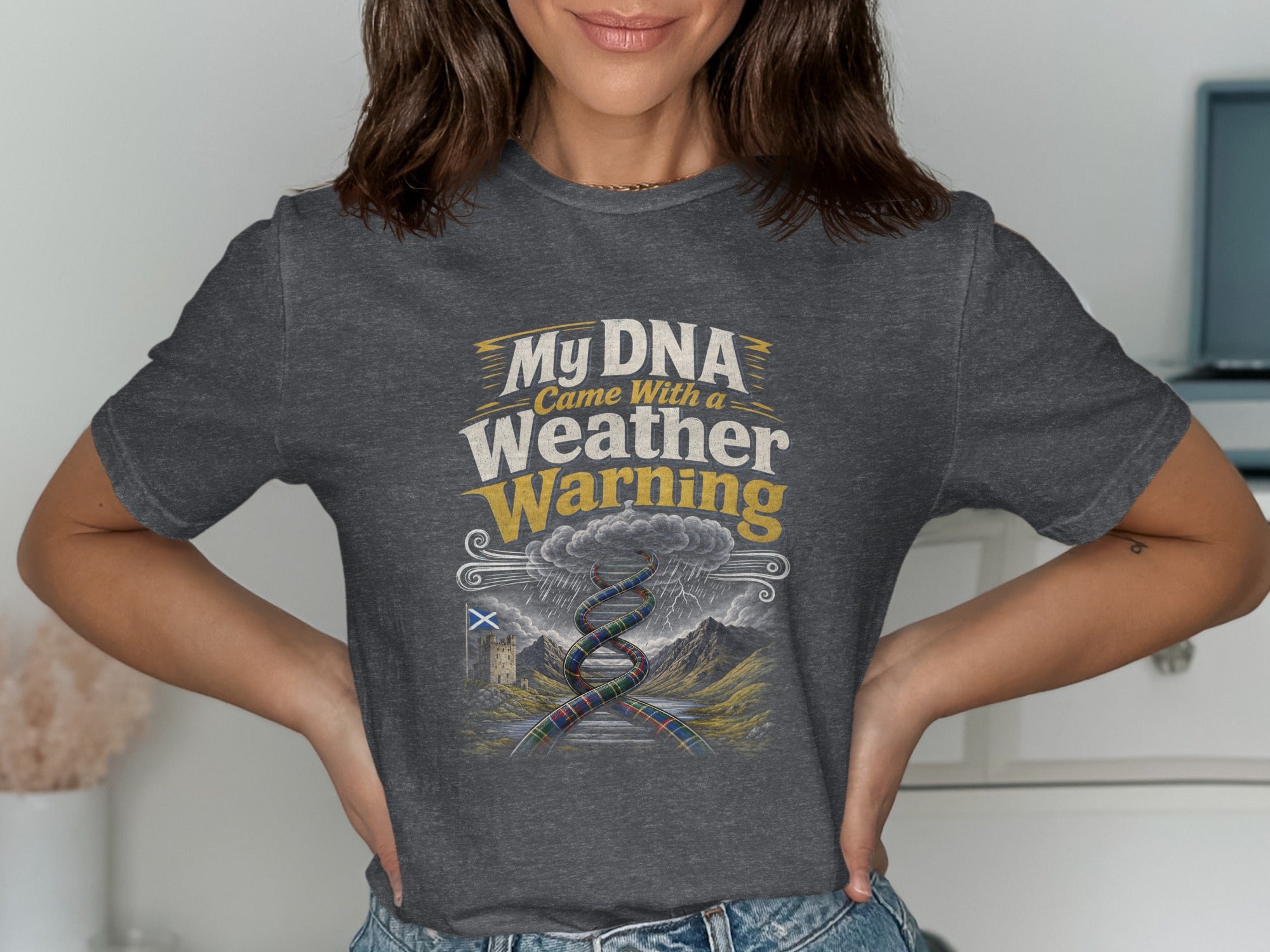 Dark t-shirt with text "My DNA Came With a Weather Warning" and a Scottish landscape.