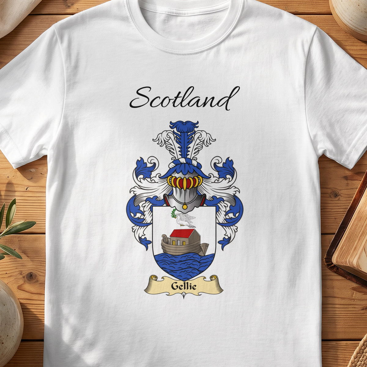 White Gellie Scottish family shield T-shirt featuring a boat on blue waves beneath a pale sky