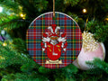 Naesmith Scottish clan ceramic ornament with family crest on a Caledonia tartan background, hanging on a Christmas tree