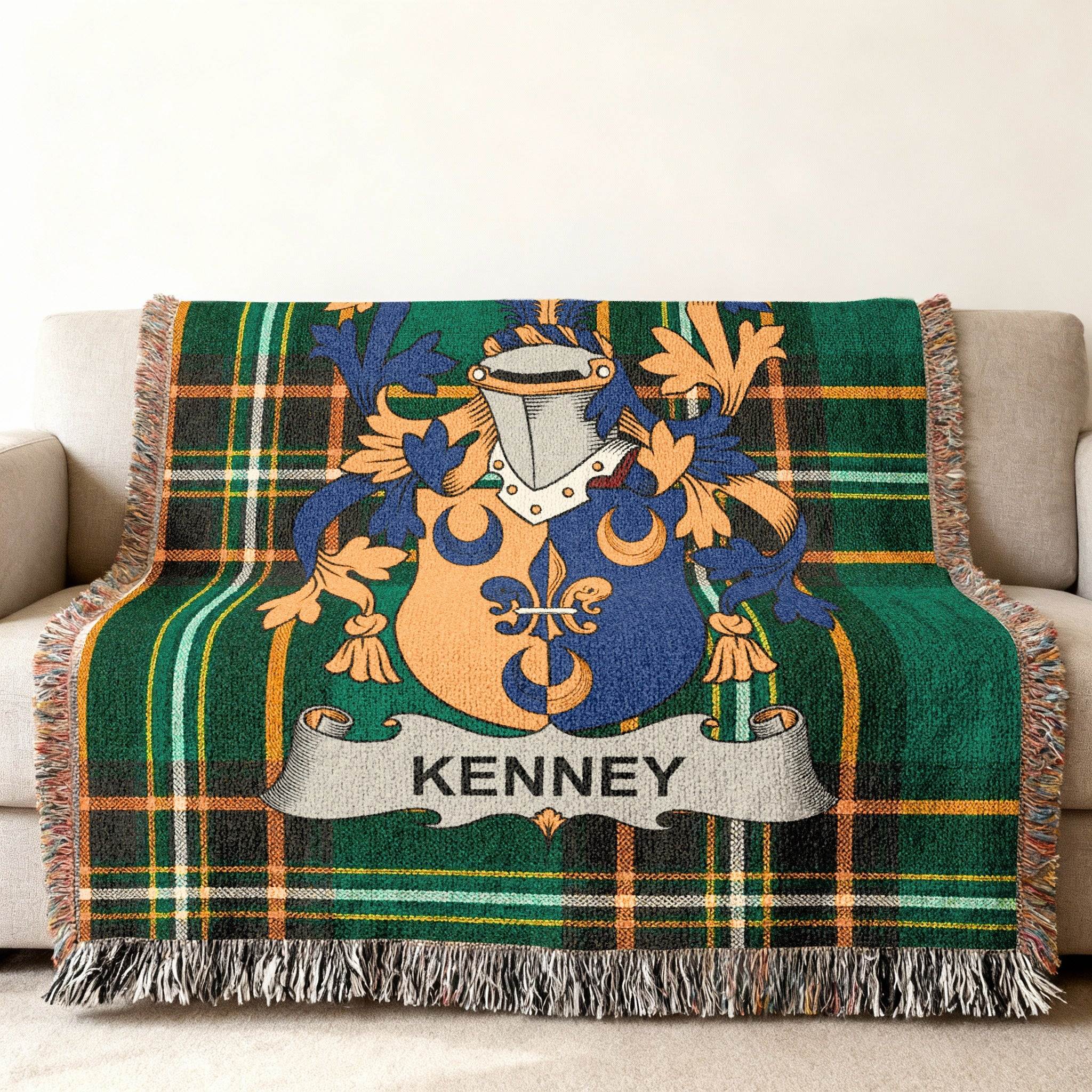 Kenney family crest on a green tartan plaid blanket with fringe.