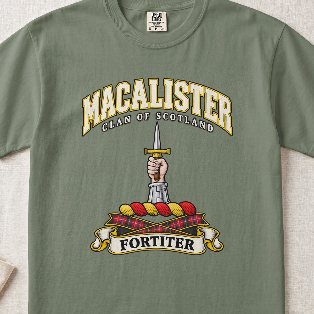 MacAlister Scottish clan T-shirt in Moss, front view with an armored arm and hand holding an upright dagger and motto design.