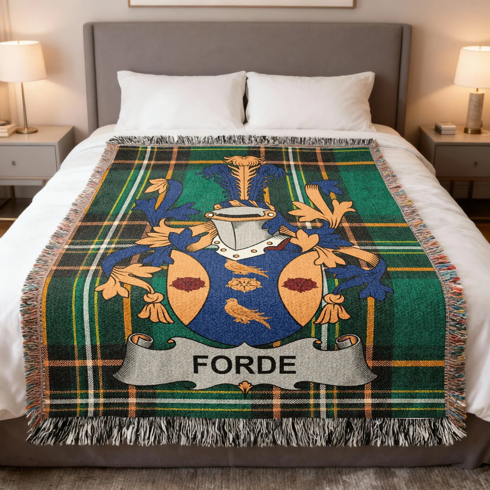 Tartan blanket with Forde family crest displayed on a bed.