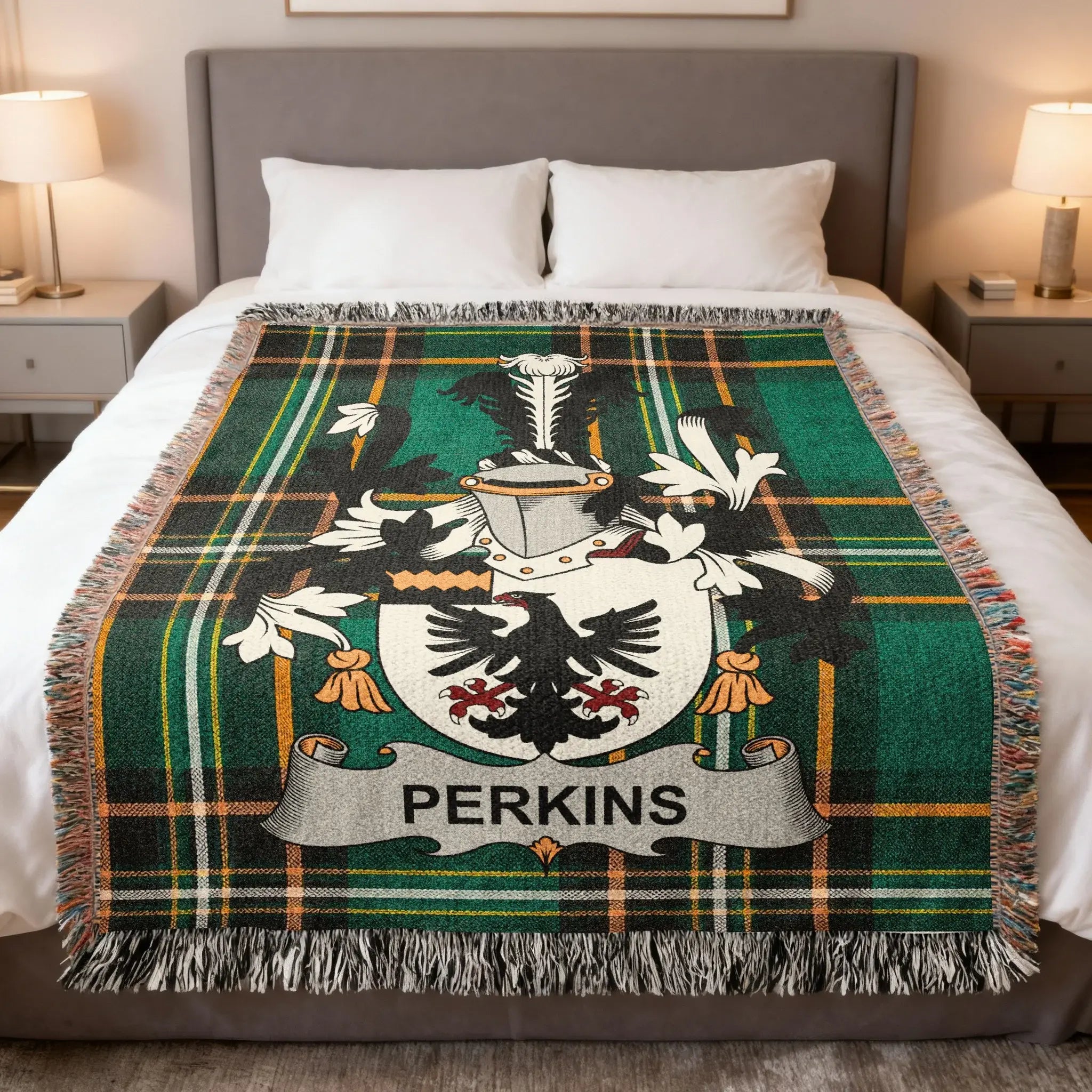 Perkins family crest on a green and black tartan blanket draped on a bed.
