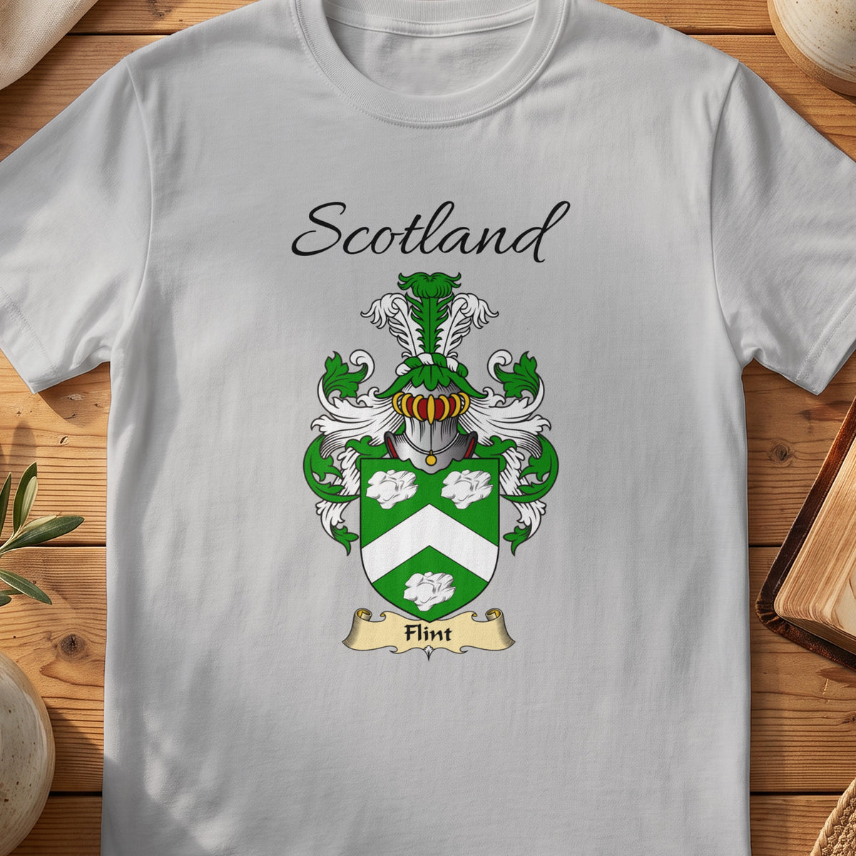 Sport Grey Flint Scottish family shield T-shirt featuring a white chevron and decorative motifs on green
